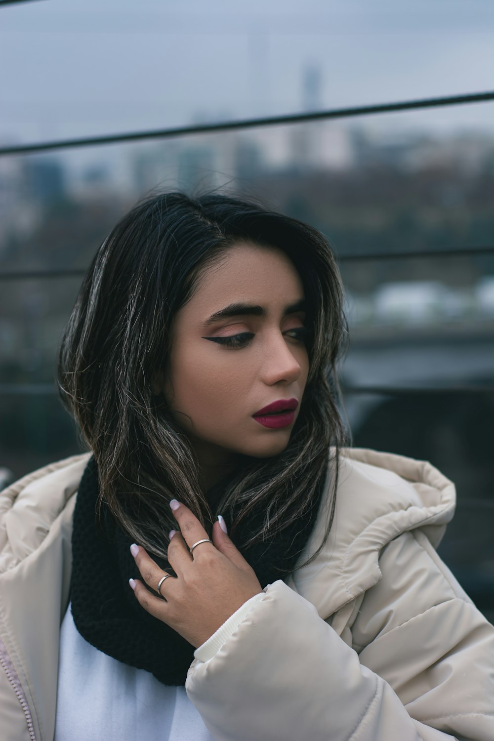 a woman wearing a white coat and a black scarf