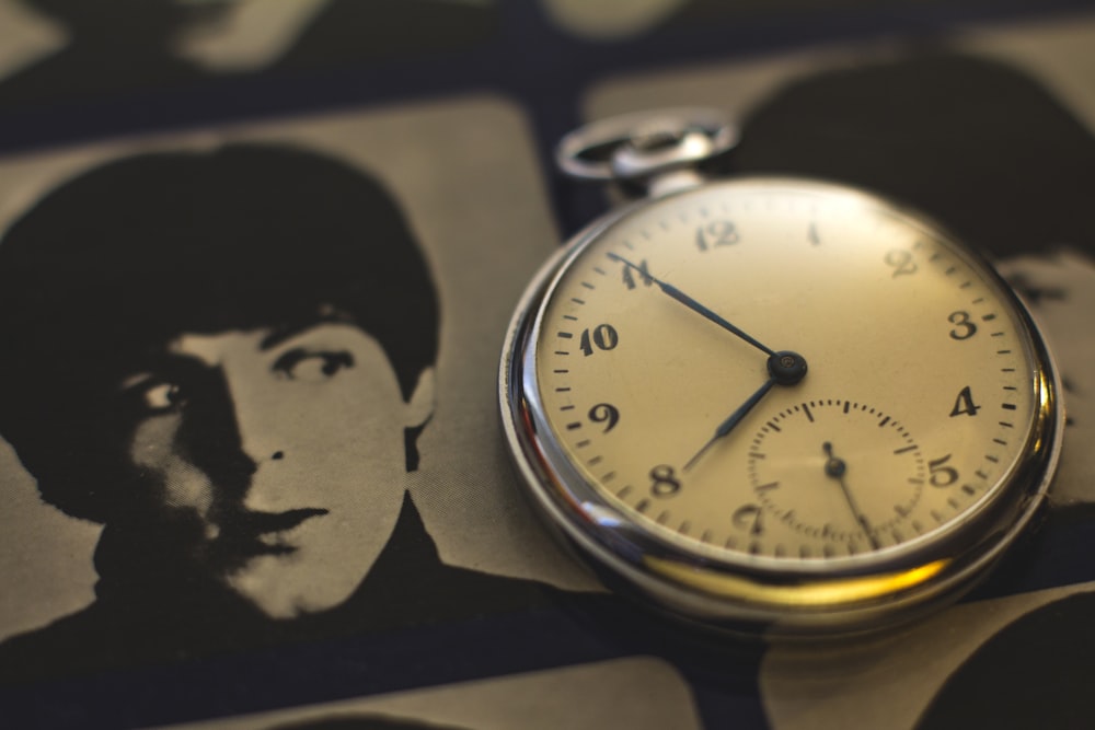 a close up of a pocket watch on a table