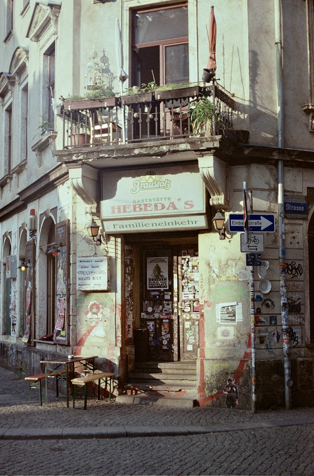 a street corner with a building with a balcony