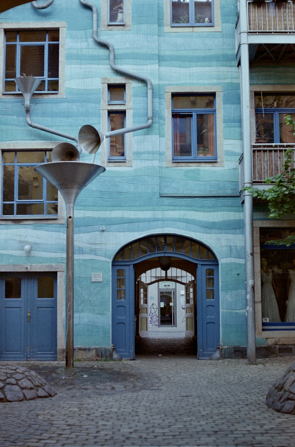 a large blue building with a clock on the front of it