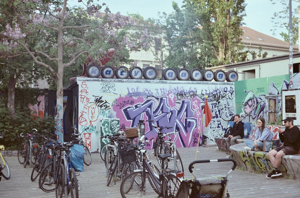 a group of people sitting on benches next to parked bikes