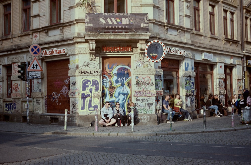 a group of people sitting outside of a building