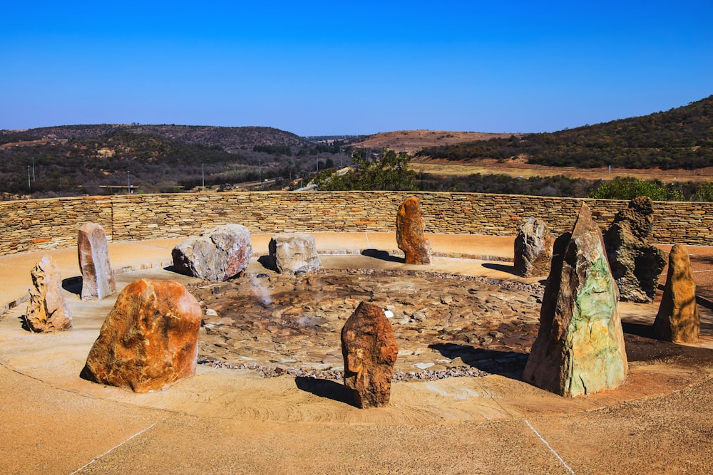 a group of rocks sitting on top of a dirt field