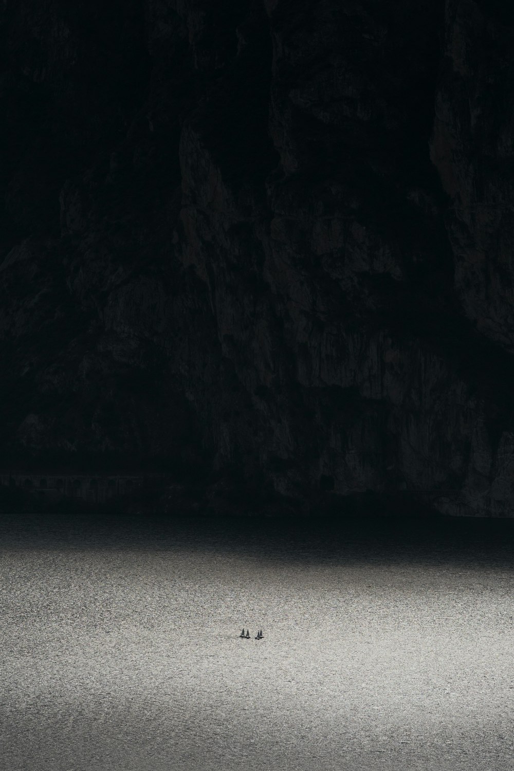 a lone boat in the middle of a body of water