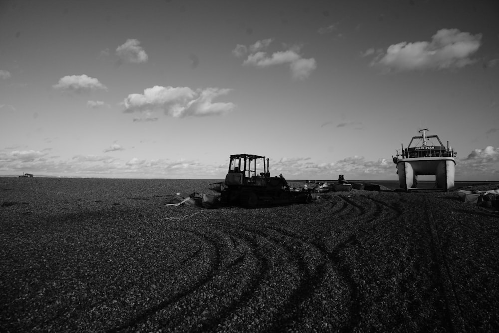 a black and white photo of a tractor in a field