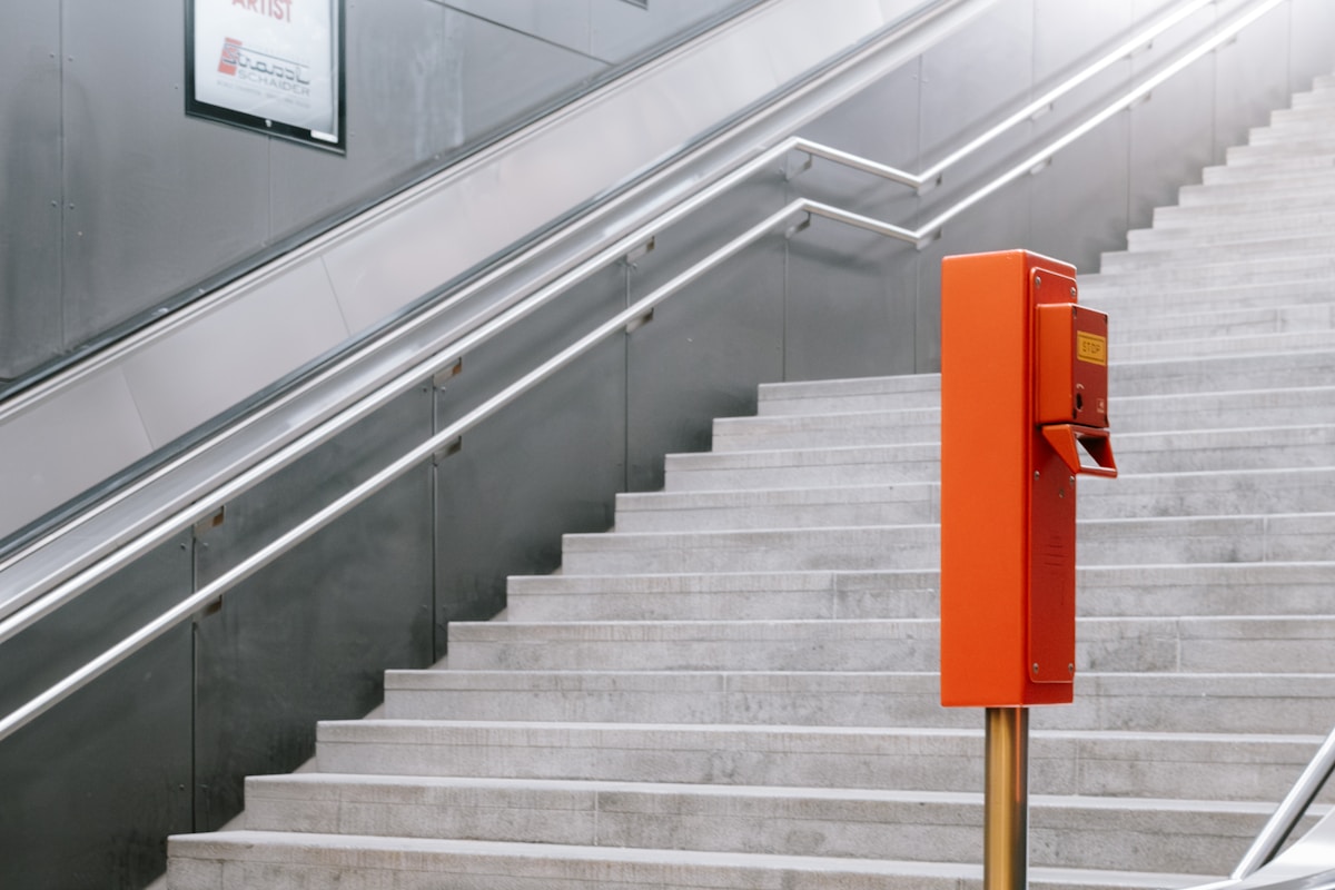 A red phone sitting on top of a set of stairs
