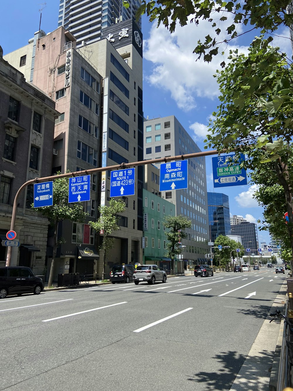 a city street with tall buildings and a traffic light