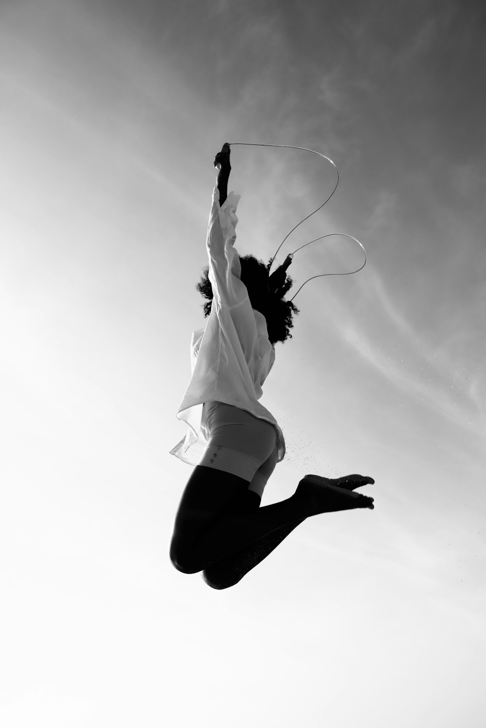 a man flying through the air while riding a kite