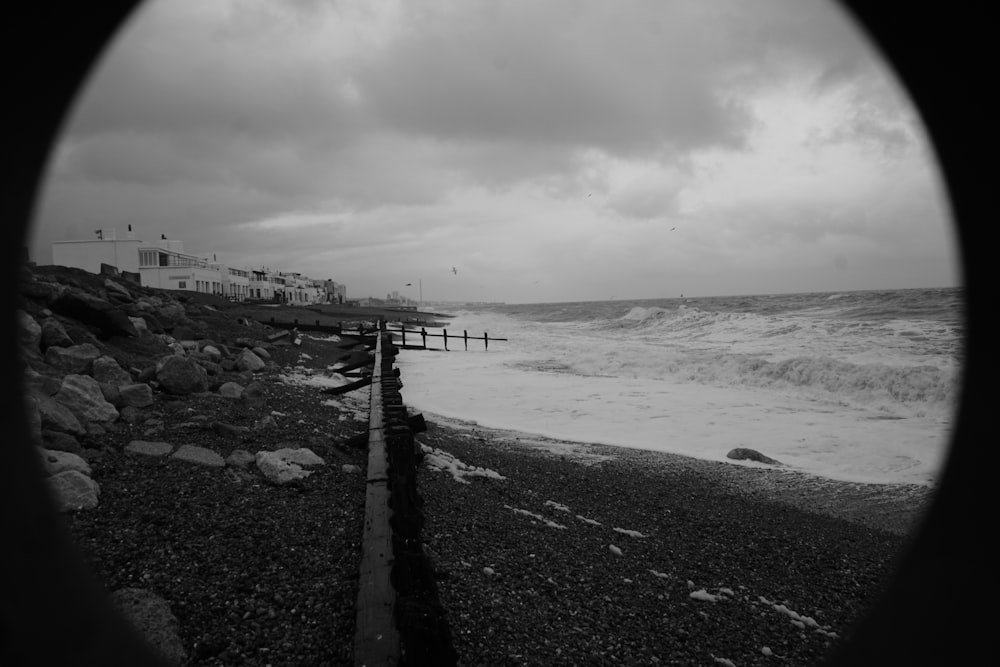 une photo en noir et blanc d’une plage avec des vagues