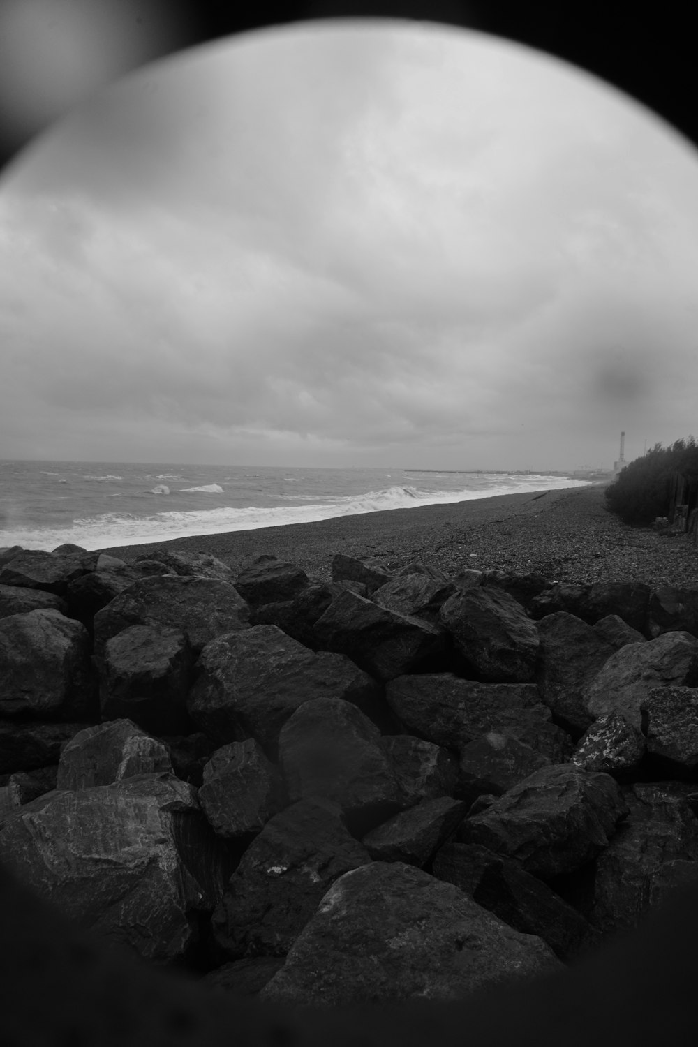 a black and white photo of a rocky beach