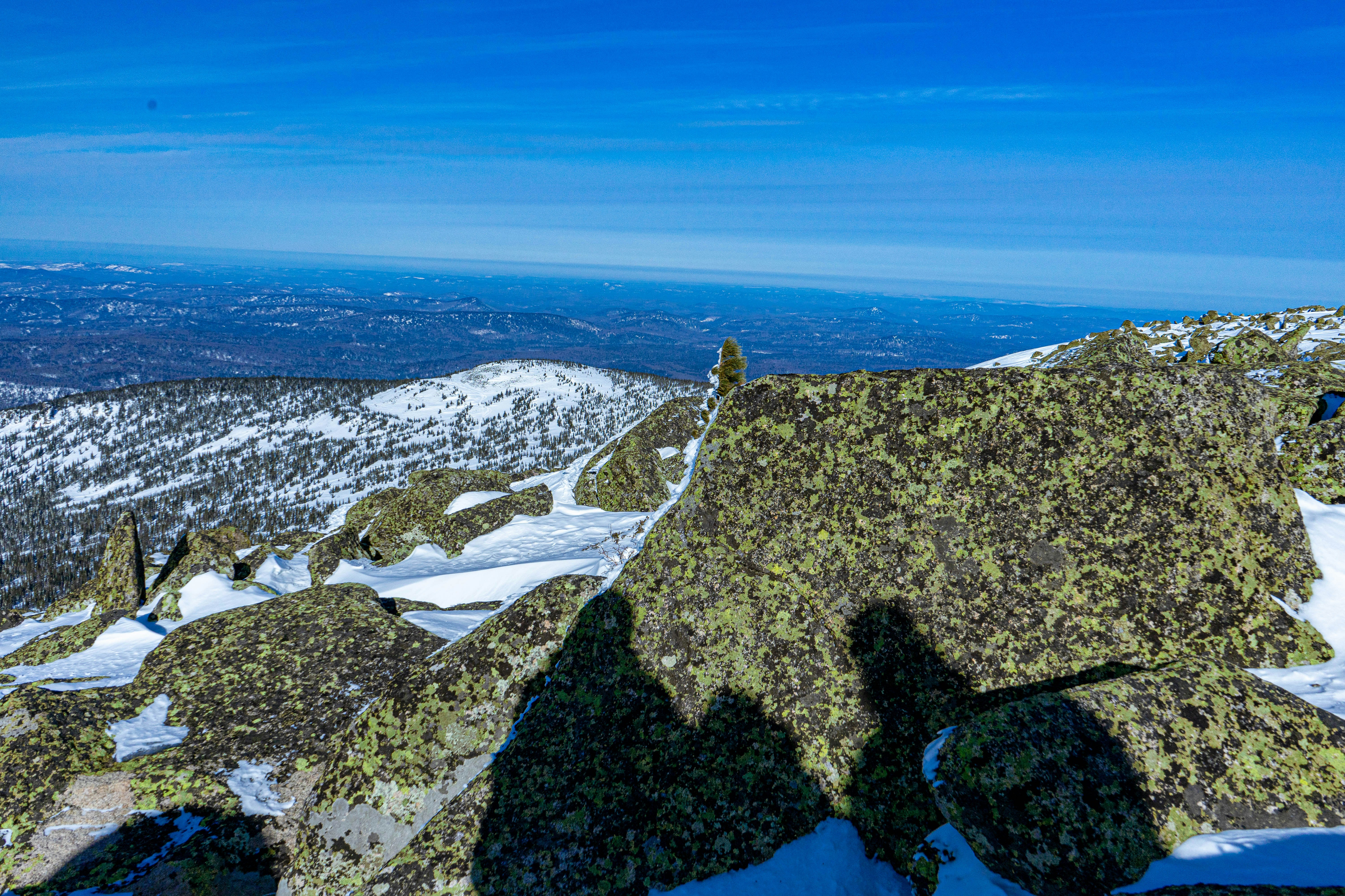 человек, стоящий на вершине заснеженной горы
