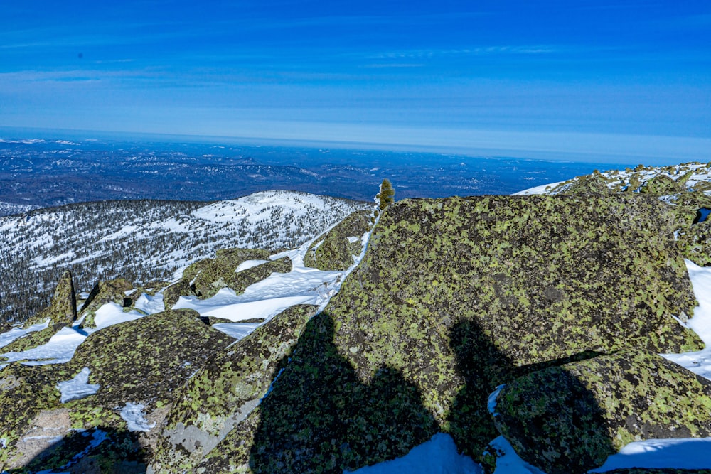 a person standing on top of a snow covered mountain