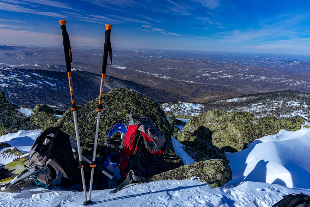 a couple of backpacks sitting on top of a snow covered slope