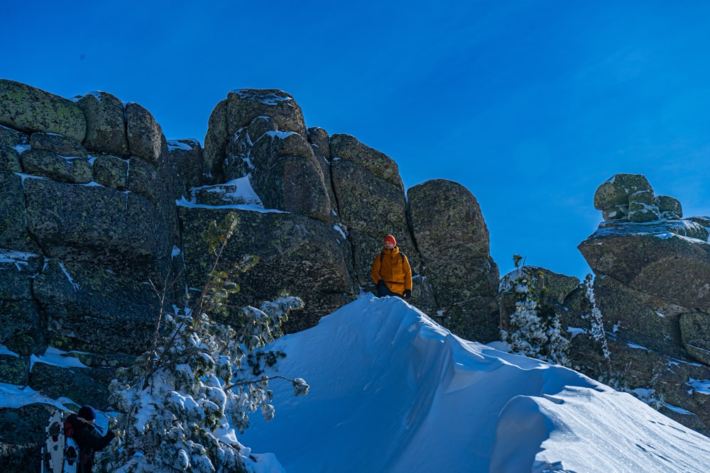 a man standing on top of a snow covered mountain