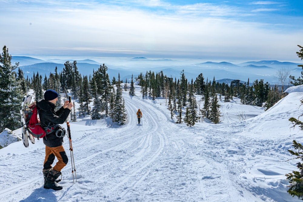 a person on skis is taking a picture of another person