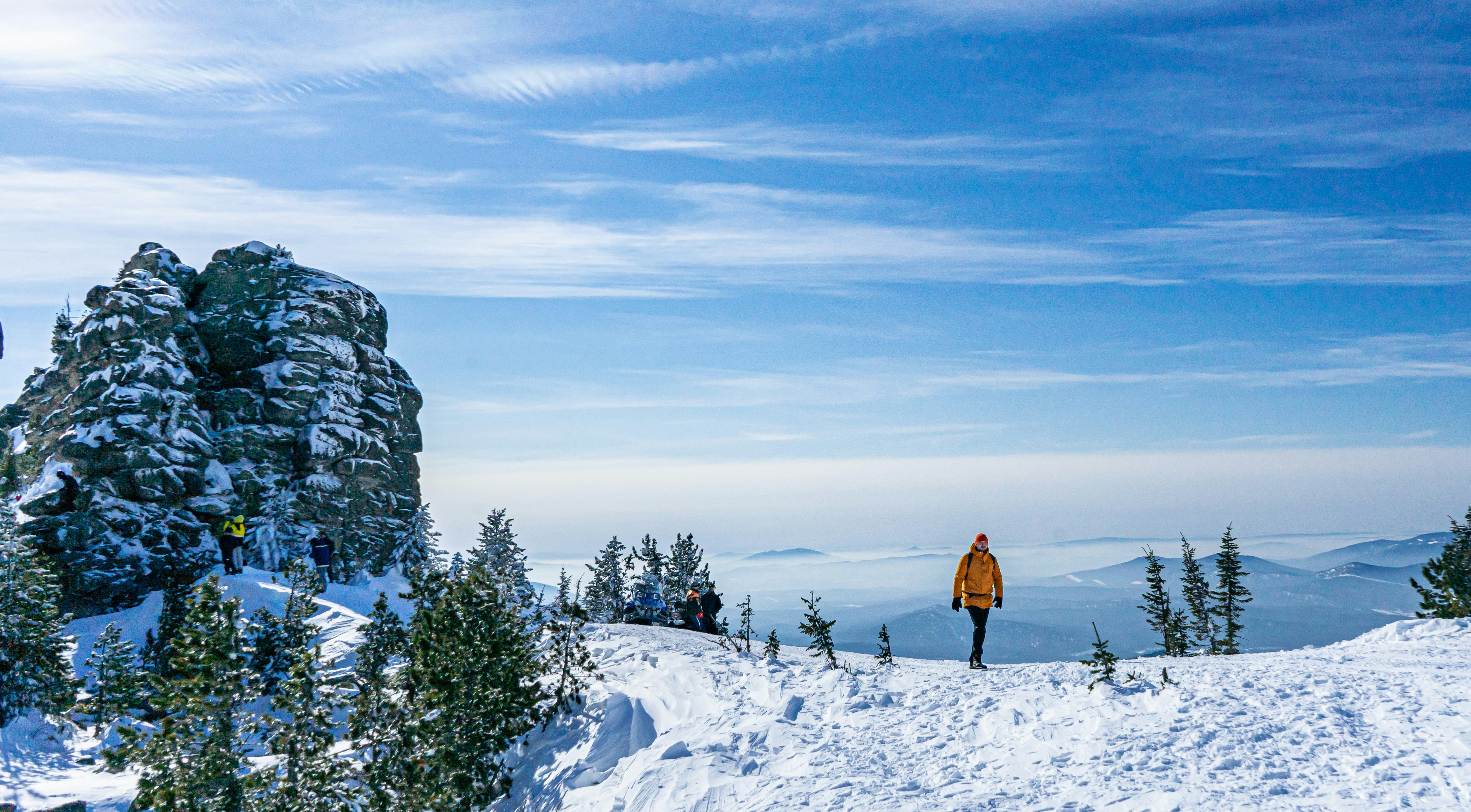 a man standing on top of a snow covered slope