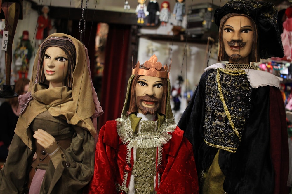 a group of puppets of people dressed in costumes