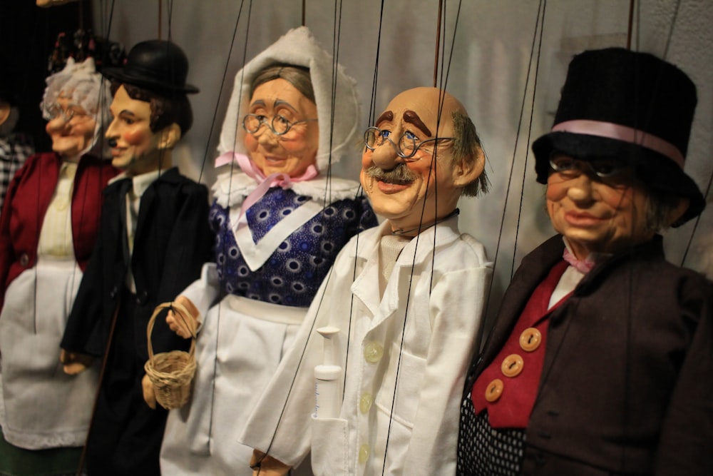 a group of puppets of people dressed in costumes