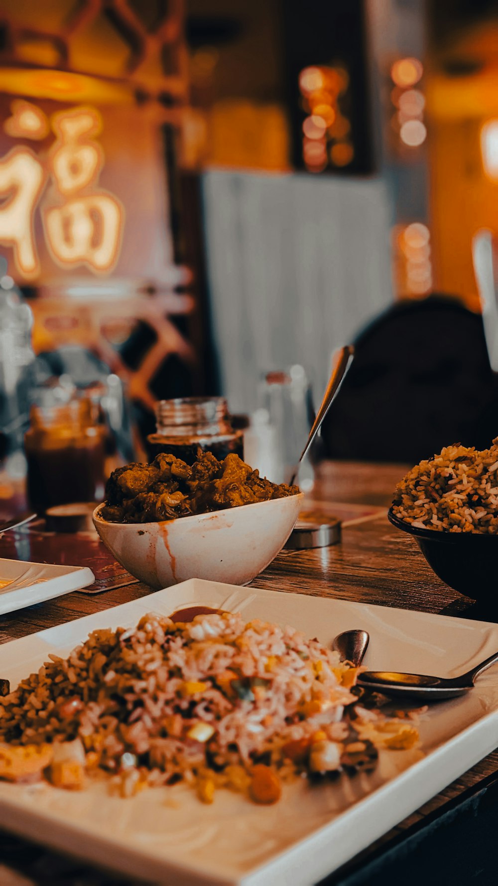 a wooden table topped with plates of food