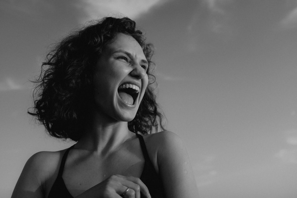 a woman with her mouth open laughing