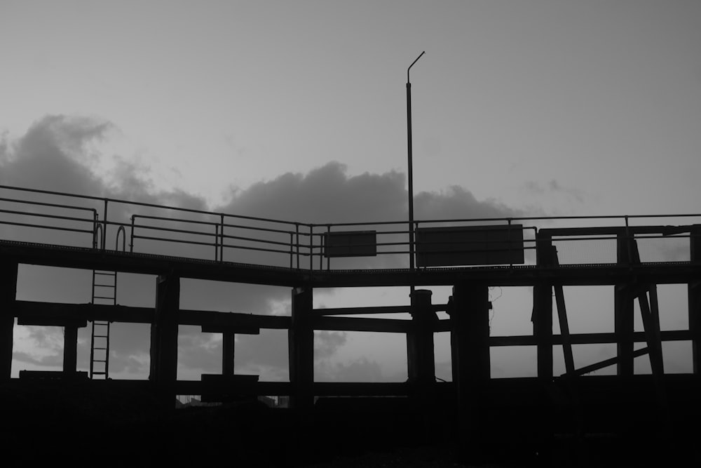 a black and white photo of a pier