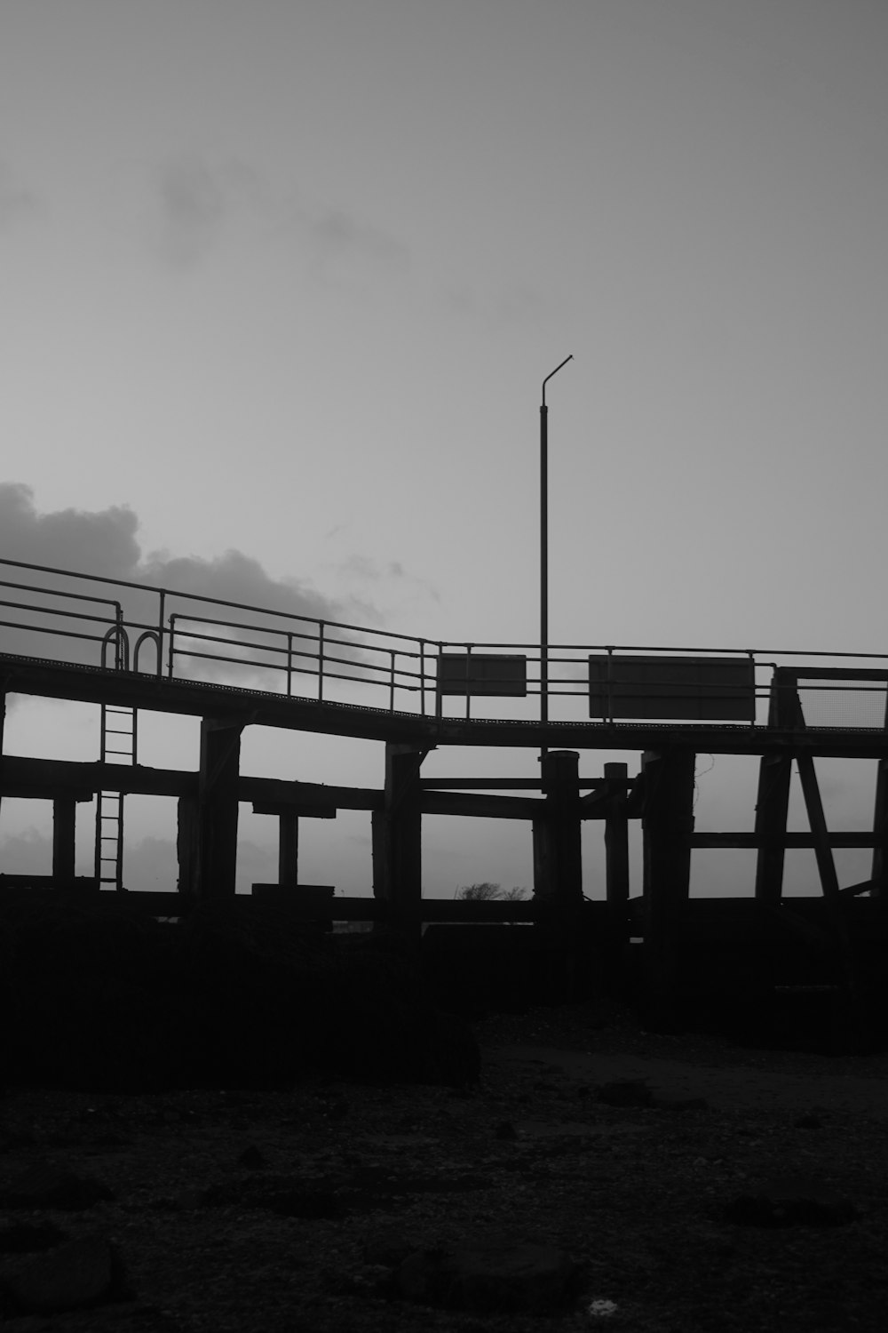 a black and white photo of a pier