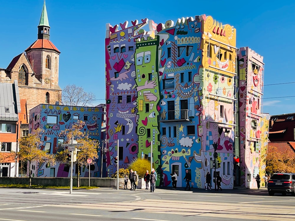 a colorful building with a clock tower in the background