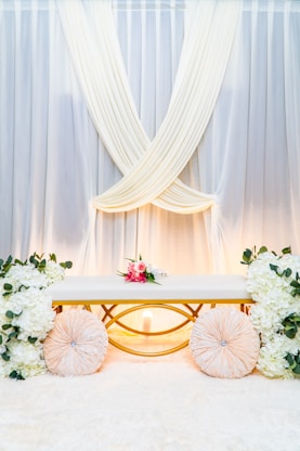 a wedding ceremony setup with flowers and umbrellas