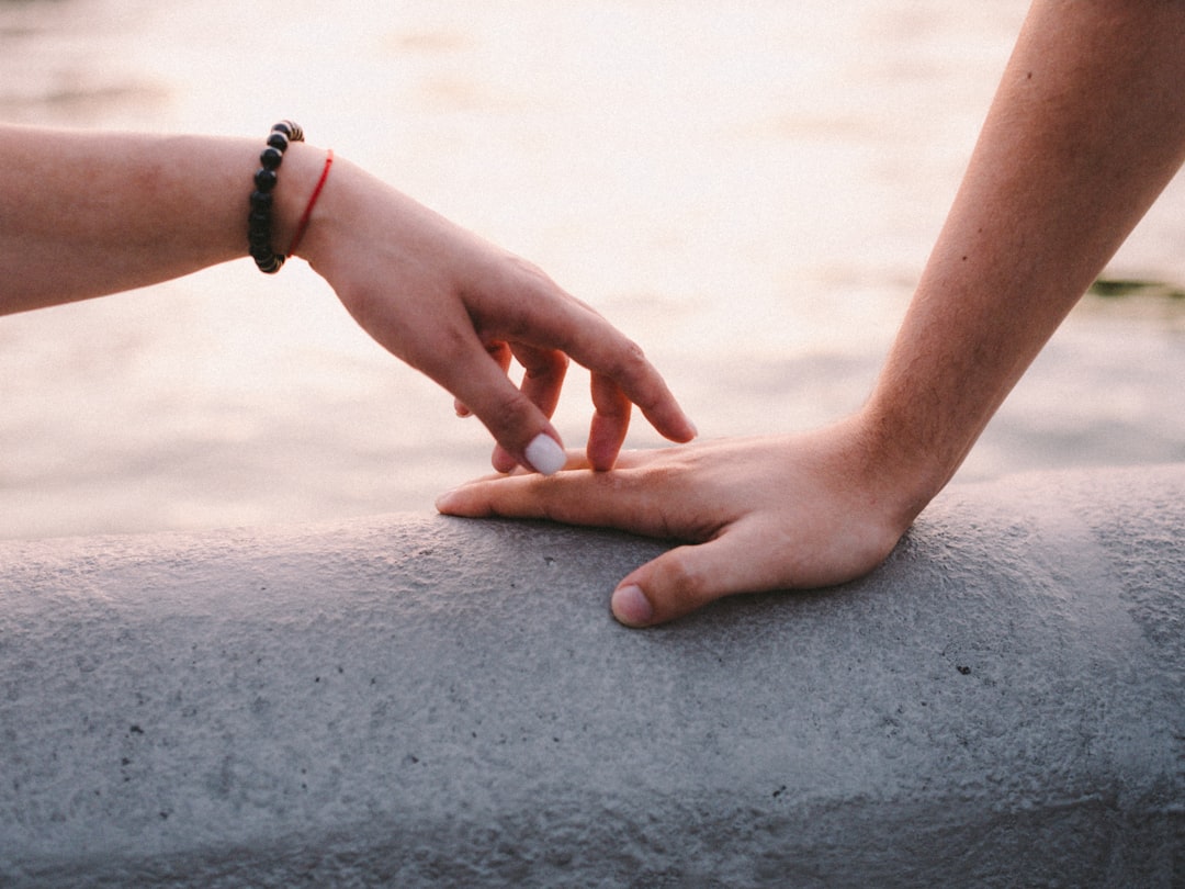 a person holding the hand of another persons hand