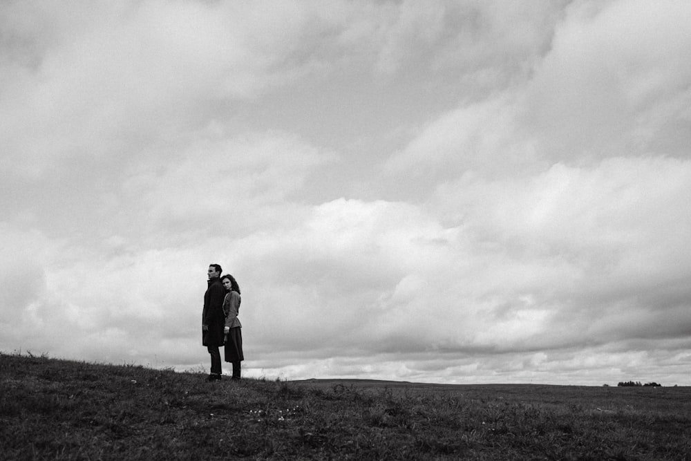 a man standing on top of a lush green field