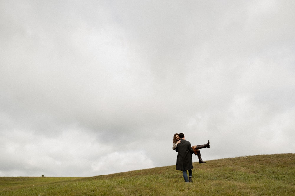 a man holding a woman up in the air