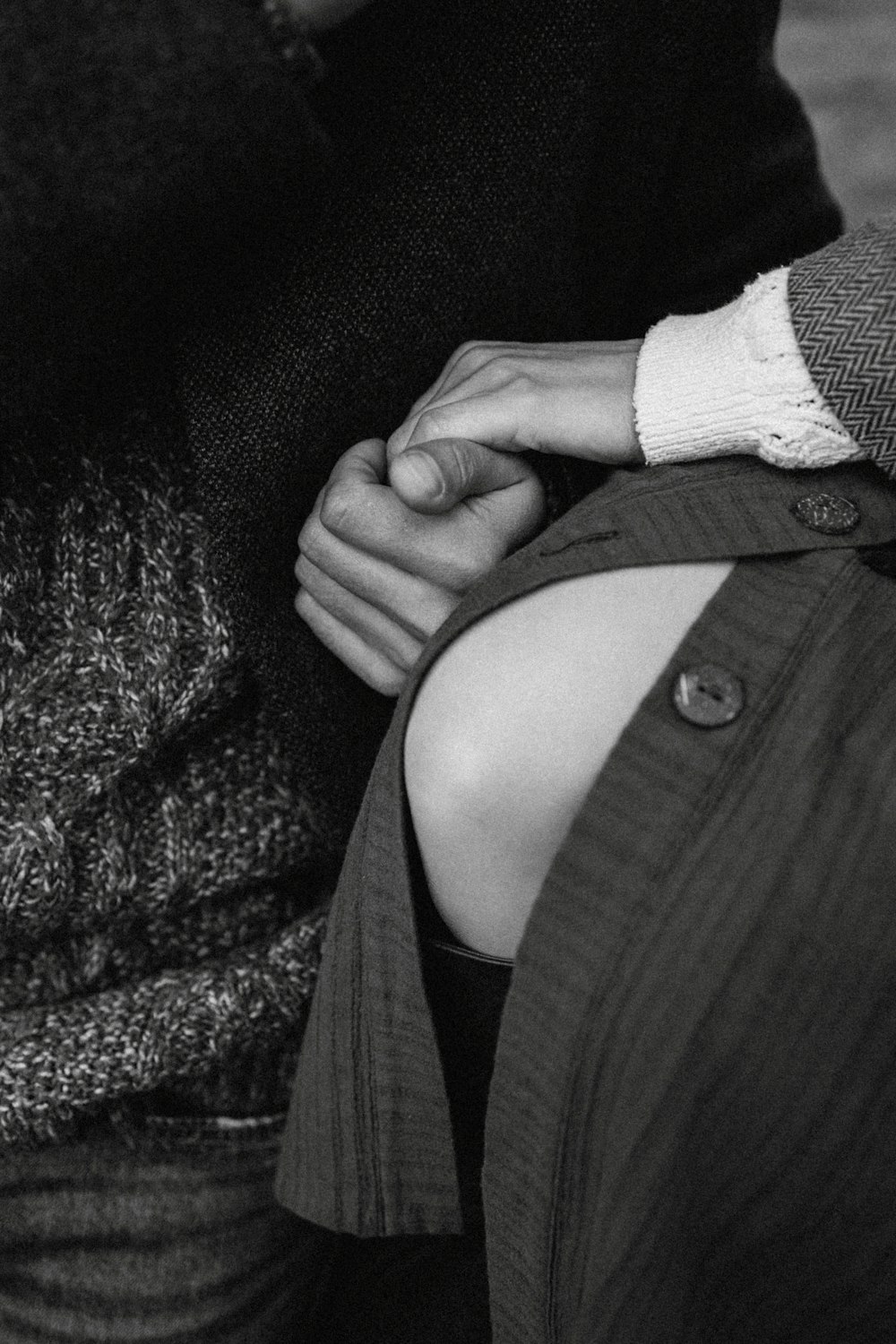 a couple holding hands while sitting on a bench