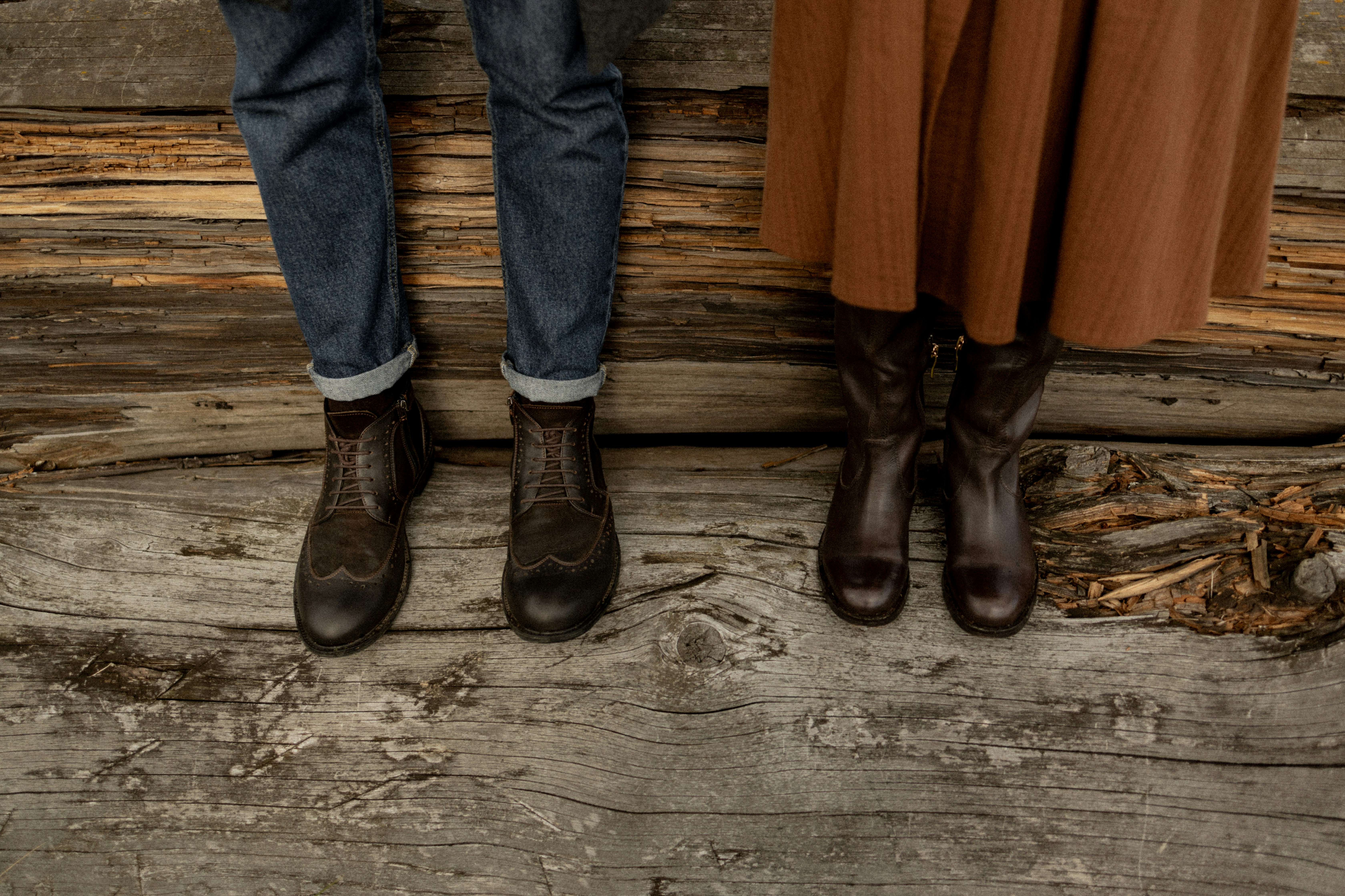 two people standing next to each other on a wooden floor