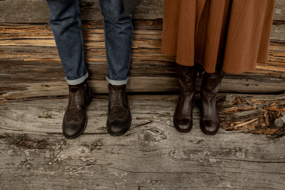 two people standing next to each other on a wooden floor