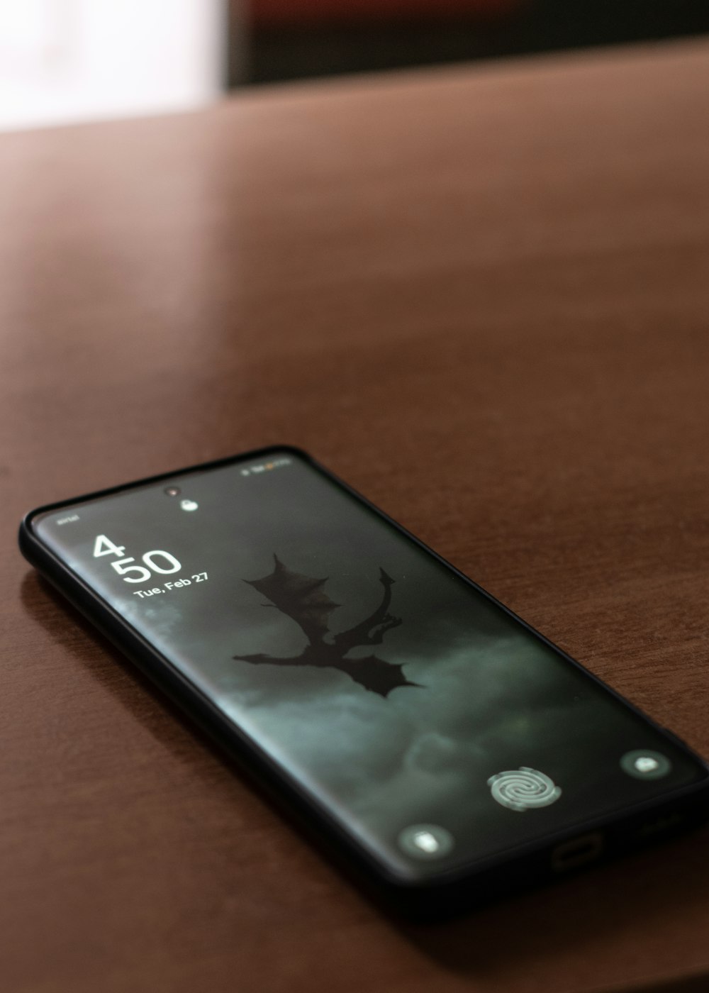 a cell phone sitting on top of a wooden table