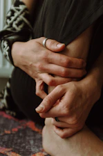 a close up of a person holding their hands together