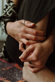 a close up of a person holding their hands together