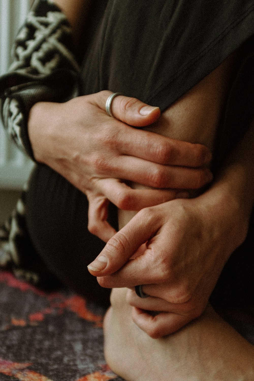 a close up of a person holding their hands together