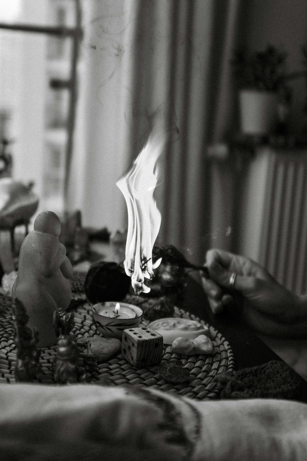 a black and white photo of a candle on a table