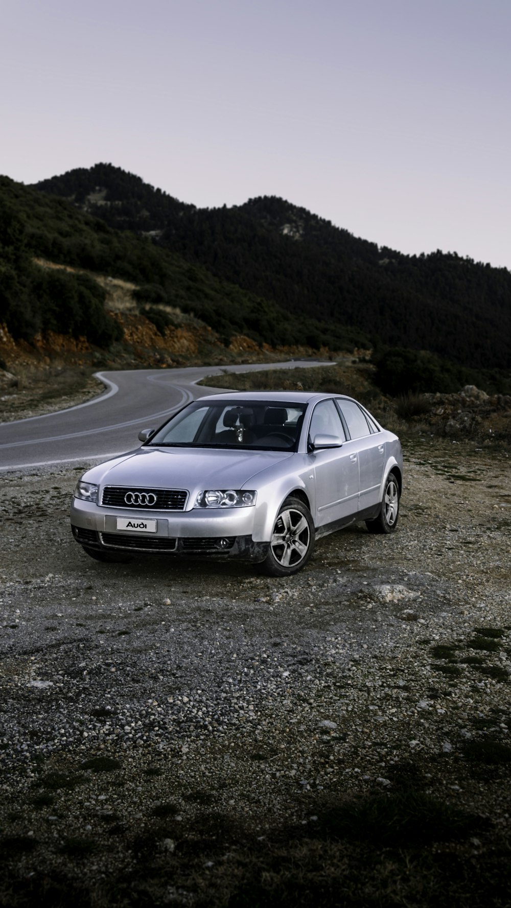 a silver car parked on the side of a road