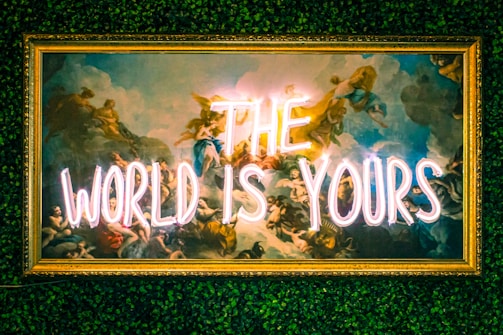 a neon sign that reads the world is yours