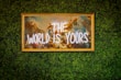 a sign that says the world is yours on a wall