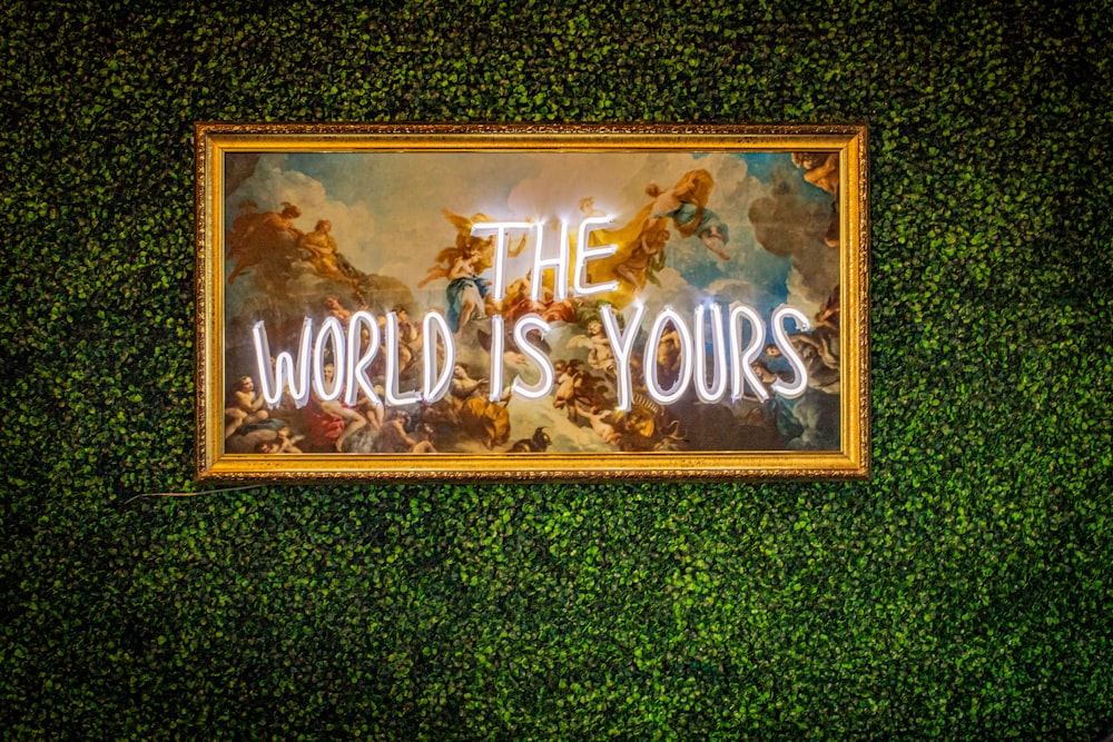 a sign that says the world is yours on a wall
