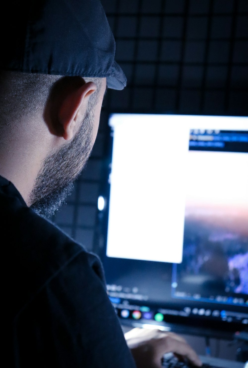 a man sitting in front of a computer monitor