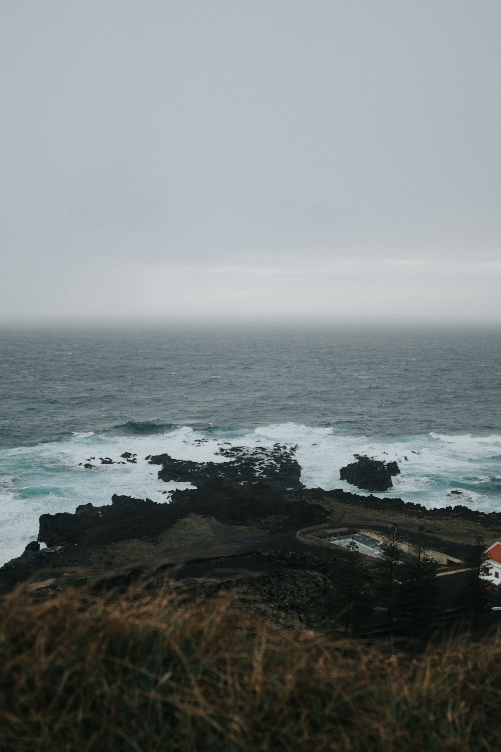 a view of the ocean from the top of a hill