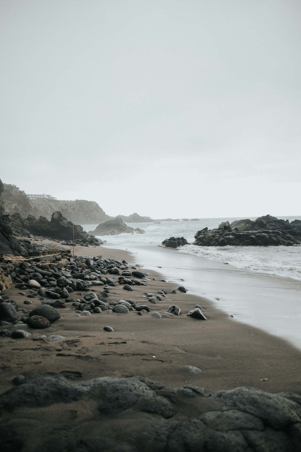 a black and white photo of a rocky beach