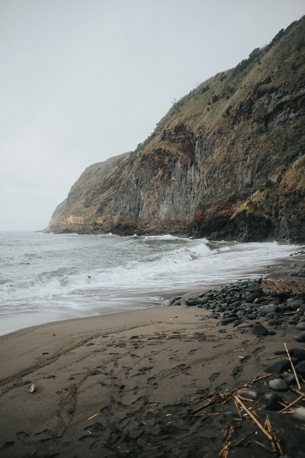 a rocky beach with waves coming in to shore