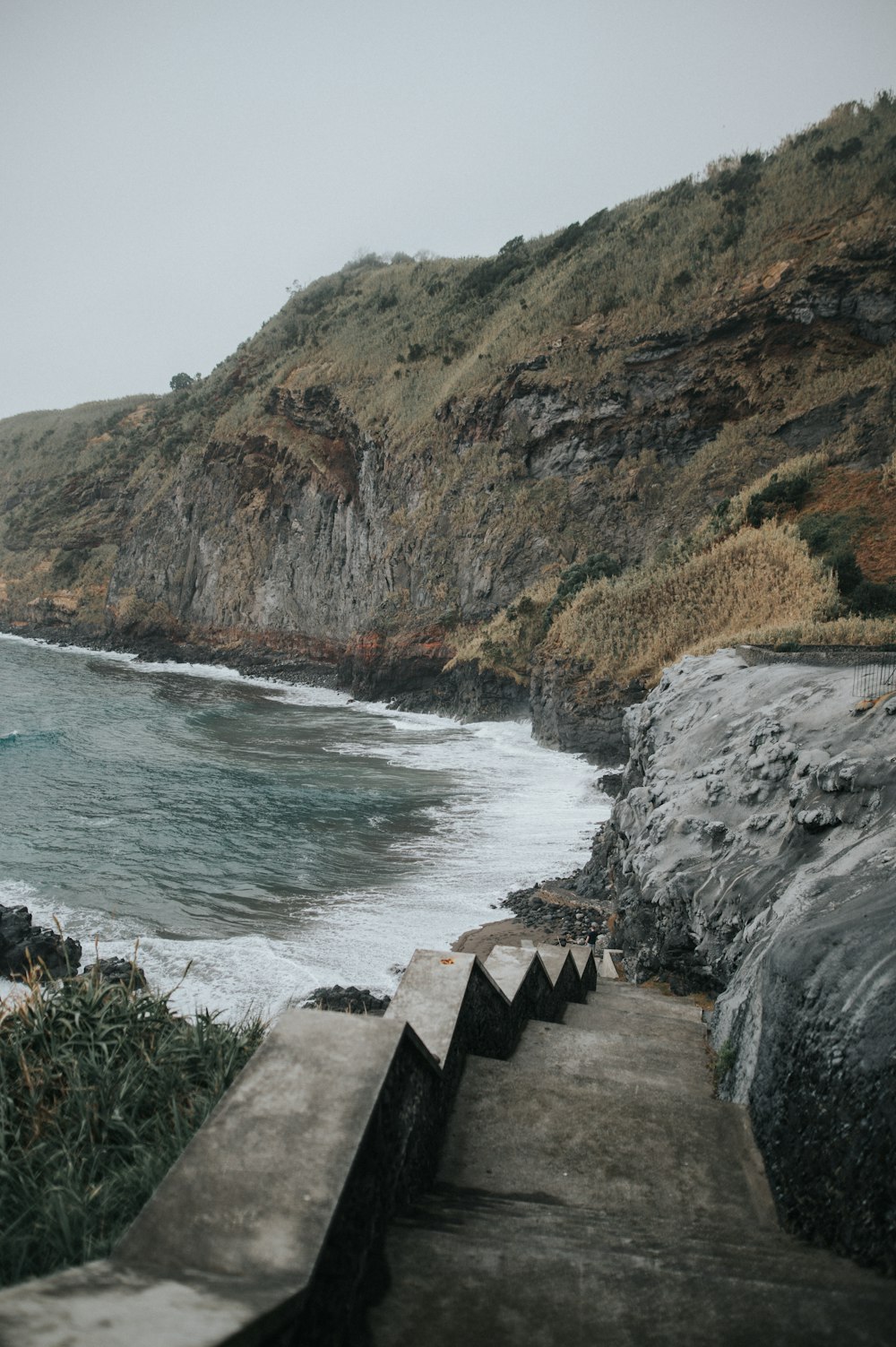 a view of the ocean from the top of a hill