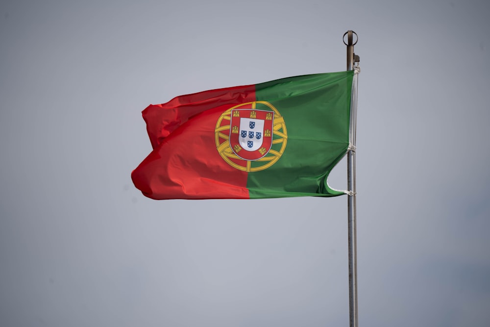 the flag of portugal flying in the wind