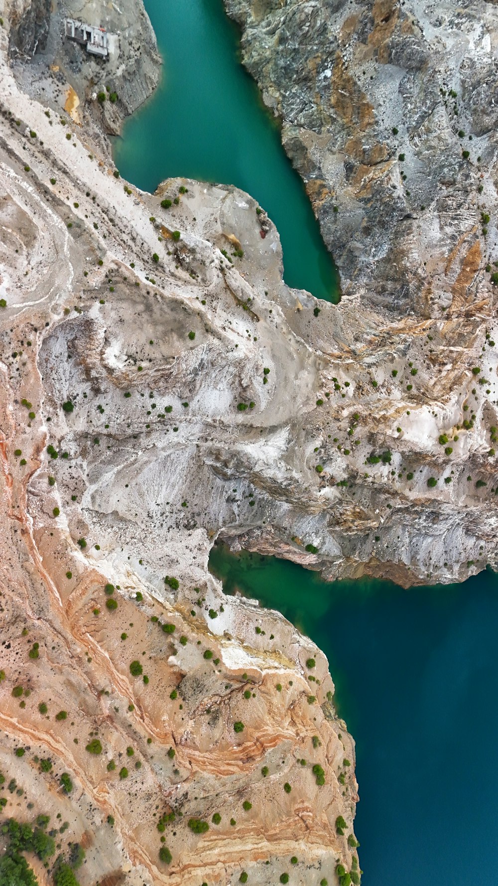 an aerial view of a lake surrounded by mountains